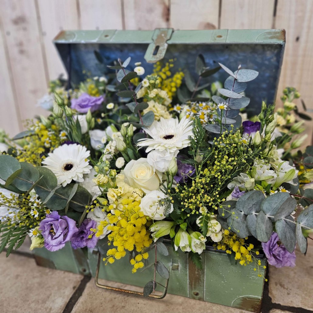 Composition florale dans une valise vintage